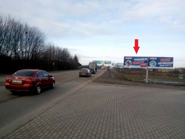 Щит 6x3,  Кільцева дорога, на перетині з Шухевича Р. вул., ліва (Гіпермарткет "Епіцентр", Гіпермаркет "МЕТРО", АЗС "БРСМ-нафта", в'їзд до автосалонів "BMW", "HONDA", "Volkswagen & Seat"), в напрямку Шевченка ву